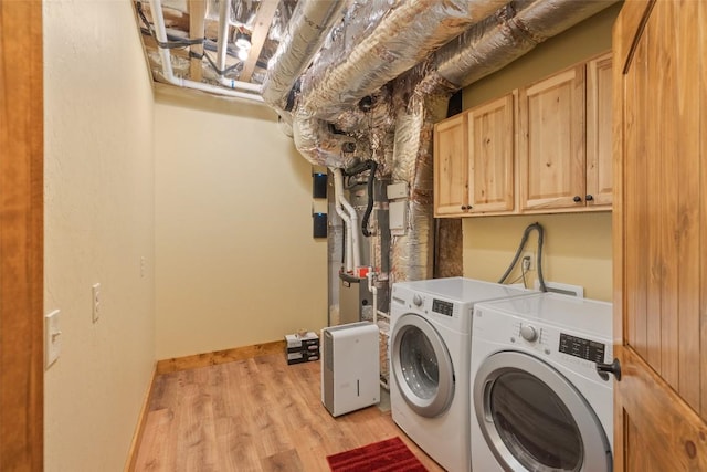 1318 Shortoff Rd, Highlands, NC 28741 - laundry room with cabinet space, washing machine and dryer, and light wood-type flooring