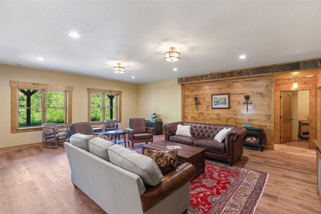 1318 Shortoff Rd, Highlands, NC 28741 - living area with light wood finished floors, recessed lighting, a wood stove, baseboards, and wooden walls