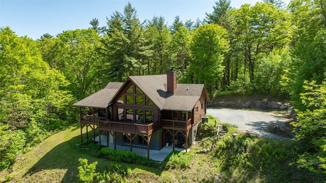 1318 Shortoff Rd, Highlands, NC 28741 - rear view of house featuring a wooden deck, a chimney, and a view of trees