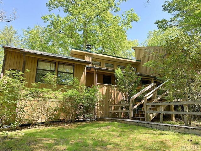 rear view of house with a lawn