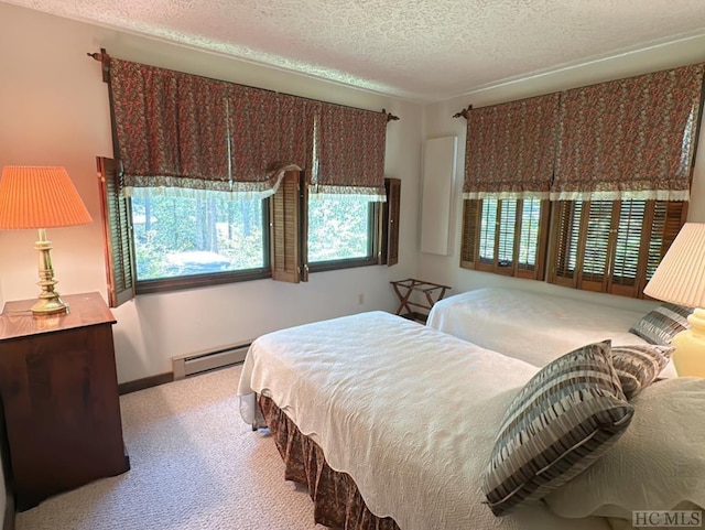 bedroom with a baseboard radiator, light carpet, and a textured ceiling