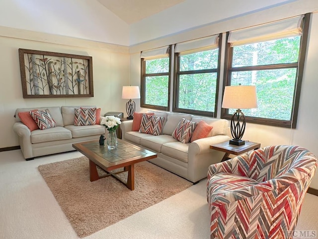 carpeted living room with vaulted ceiling