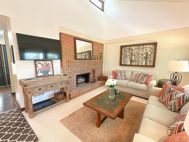 living room featuring a towering ceiling, a fireplace, and carpet floors