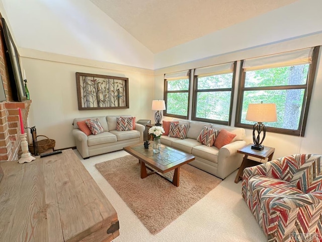 carpeted living room featuring high vaulted ceiling and a fireplace