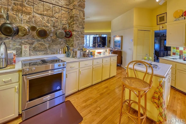 kitchen with high end stove and light wood-type flooring