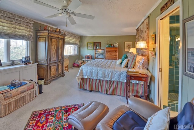 carpeted bedroom featuring ornamental molding, a textured ceiling, and ceiling fan