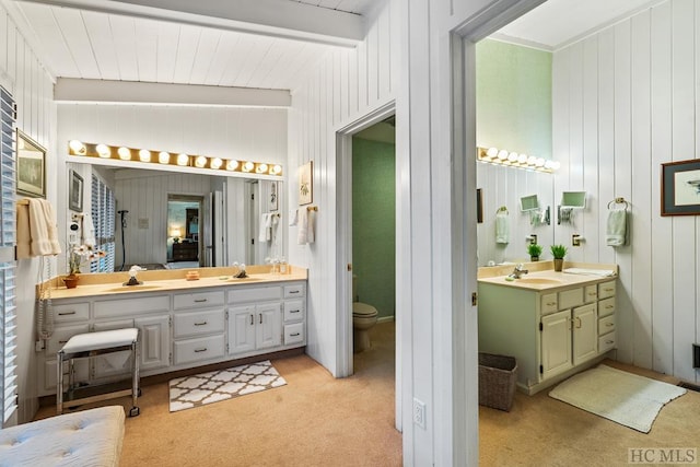 bathroom featuring toilet, vanity, and vaulted ceiling