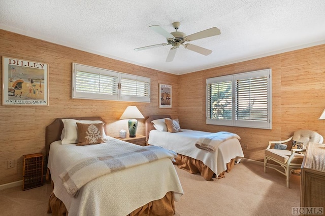 bedroom featuring a textured ceiling, carpet flooring, and ceiling fan