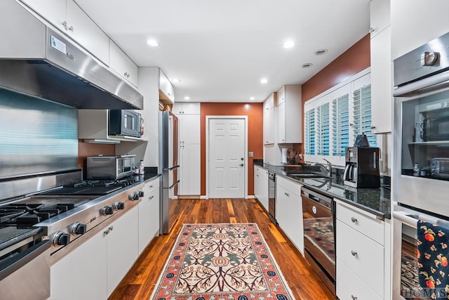 kitchen featuring stainless steel appliances, wine cooler, sink, white cabinets, and dark hardwood / wood-style floors