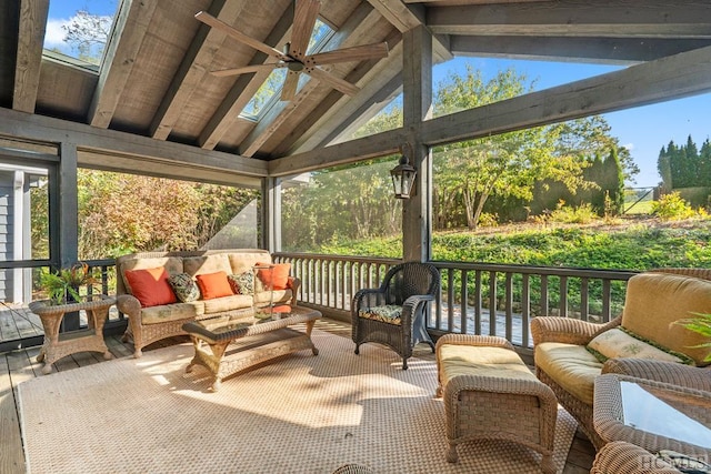 sunroom / solarium with ceiling fan and lofted ceiling with beams