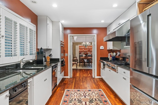 kitchen featuring sink, dark stone countertops, white cabinetry, and stainless steel appliances