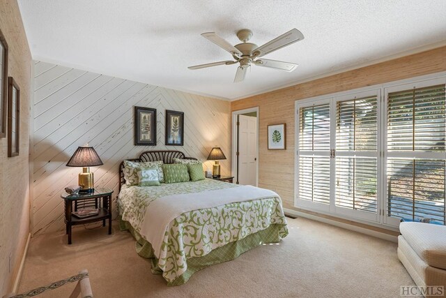 bedroom with carpet, ceiling fan, and a textured ceiling