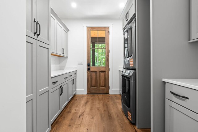 1310 New Settlers Way, Glenville, NC 28736 - washroom featuring stacked washing machine and dryer, cabinet space, wood finished floors, and recessed lighting