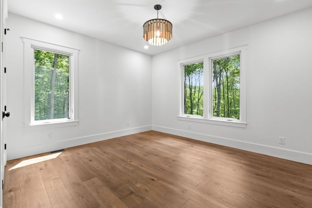 1310 New Settlers Way, Glenville, NC 28736 - spare room featuring healthy amount of natural light, a chandelier, wood finished floors, and recessed lighting
