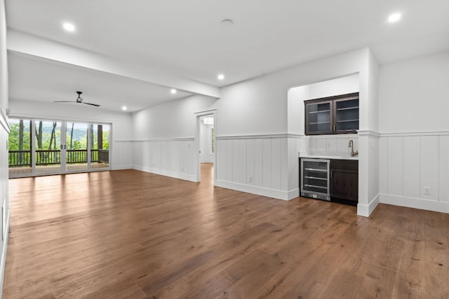 1310 New Settlers Way, Glenville, NC 28736 - unfurnished living room with beverage cooler, wainscoting, recessed lighting, a ceiling fan, and wood finished floors