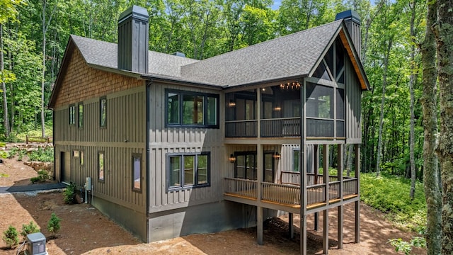 1310 New Settlers Way, Glenville, NC 28736 - back of property featuring roof with shingles, a chimney, a sunroom, and a wooden deck