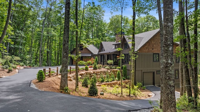 1310 New Settlers Way, Glenville, NC 28736 - chalet / cabin with driveway, a garage, a chimney, and roof with shingles