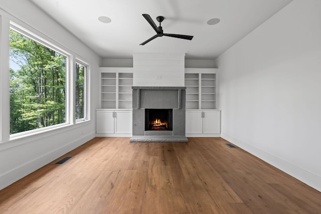 1310 New Settlers Way, Glenville, NC 28736 - unfurnished living room with a large fireplace, wood finished floors, and ceiling fan
