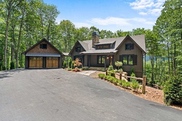 1310 New Settlers Way, Glenville, NC 28736 - rustic home with a chimney, a metal roof, a standing seam roof, a detached garage, and an outbuilding