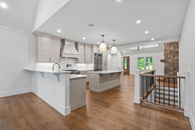 1310 New Settlers Way, Glenville, NC 28736 - kitchen with premium range hood, stainless steel built in refrigerator, a kitchen breakfast bar, a peninsula, and light countertops