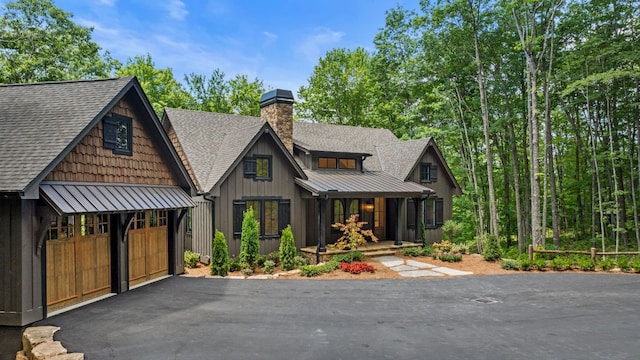 1310 New Settlers Way, Glenville, NC 28736 - view of front of property with a standing seam roof, a shingled roof, covered porch, and a garage