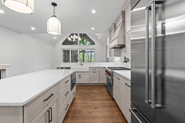 1310 New Settlers Way, Glenville, NC 28736 - kitchen with high quality appliances, vaulted ceiling, light countertops, dark wood-type flooring, and decorative light fixtures