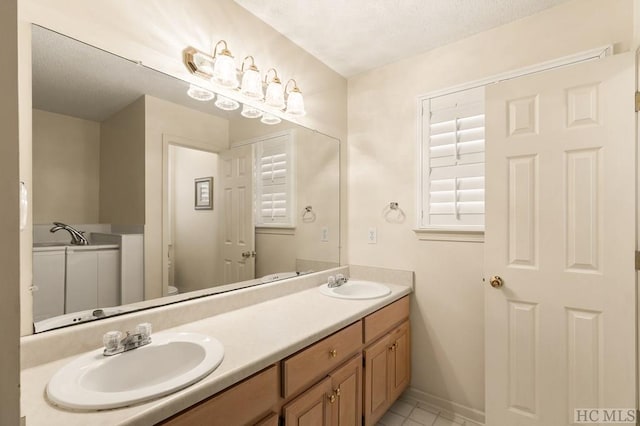 bathroom with vanity, tile patterned floors, a textured ceiling, and toilet