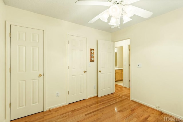 unfurnished bedroom with ceiling fan and light wood-type flooring