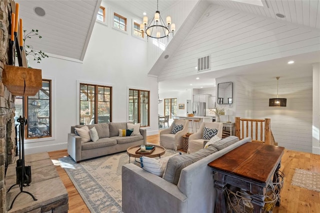 111 Chapel Hl, Cashiers, NC 28717 - living room featuring high vaulted ceiling, light wood-style floors, a chandelier, baseboards, and recessed lighting
