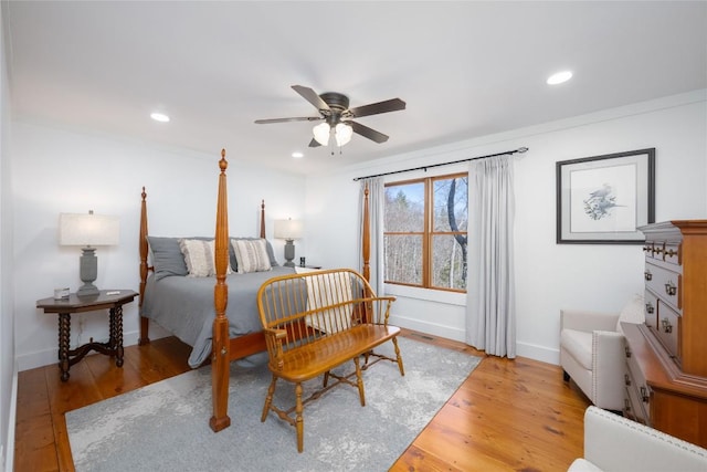 bedroom featuring light wood-style floors, recessed lighting, ornamental molding, and baseboards