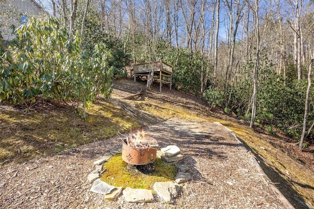 exterior space with a forest view and a deck