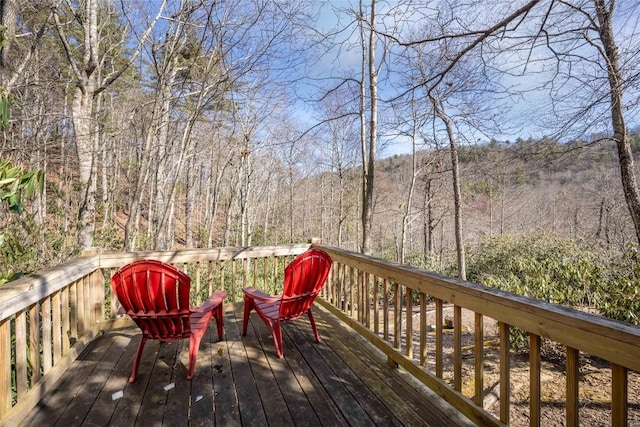 wooden deck featuring a view of trees