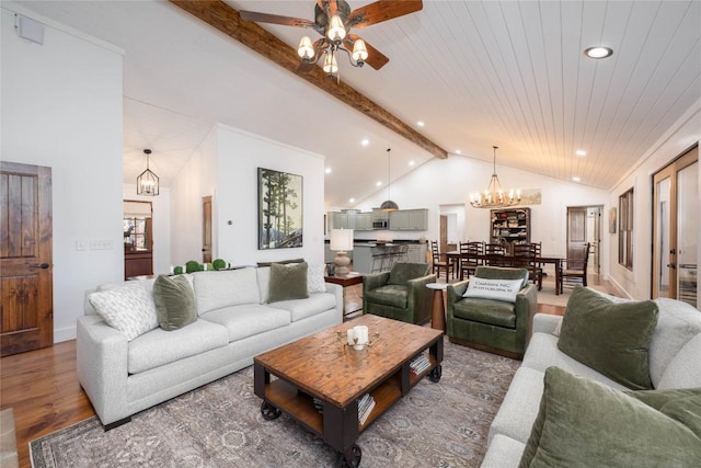 living area with lofted ceiling with beams, recessed lighting, ceiling fan with notable chandelier, wood finished floors, and wood ceiling