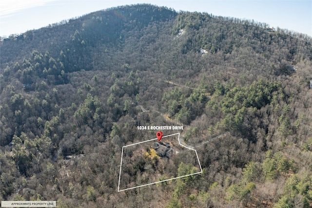 exterior space featuring a wooded view