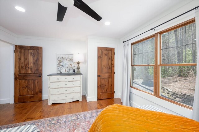 unfurnished bedroom with ceiling fan, baseboards, wood finished floors, and recessed lighting