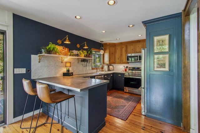 15 Elm Ct, Highlands, NC 28741 - kitchen with stainless steel appliances, a peninsula, backsplash, light wood-type flooring, and recessed lighting