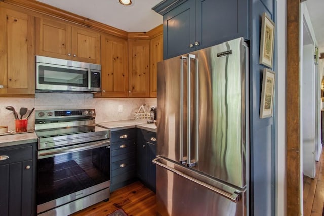 15 Elm Ct, Highlands, NC 28741 - kitchen featuring stainless steel appliances, light countertops, dark wood finished floors, tasteful backsplash, and recessed lighting