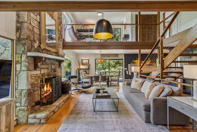 15 Elm Ct, Highlands, NC 28741 - living area with a stone fireplace, wood-type flooring, and a towering ceiling