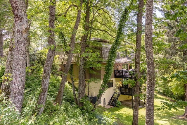 15 Elm Ct, Highlands, NC 28741 - exterior space with stucco siding, stairway, a deck, and a yard