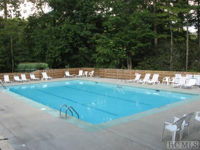 view of swimming pool with a patio area