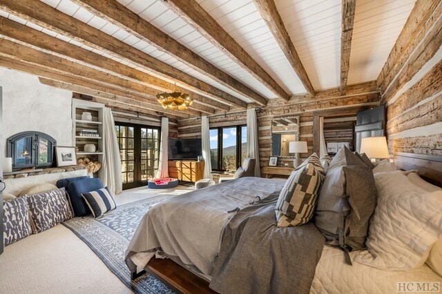 carpeted bedroom with rustic walls, french doors, beamed ceiling, and access to outside