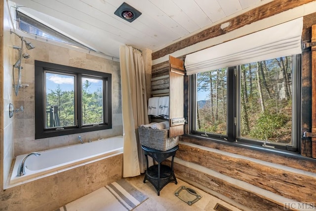 bathroom with wood ceiling, separate shower and tub, vaulted ceiling, and a wealth of natural light