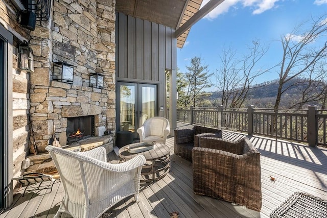 353 Gristmill Rdg, Cashiers, NC 28717 - wooden deck with french doors and an outdoor stone fireplace