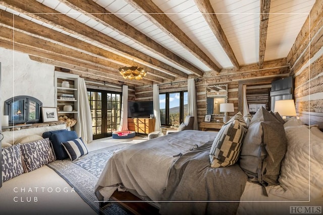 bedroom featuring french doors, beamed ceiling, and access to exterior