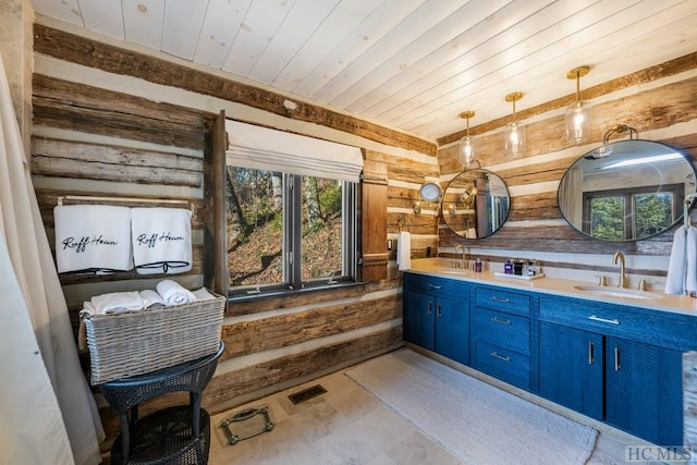 bathroom featuring vanity, wooden walls, wooden ceiling, and rustic walls