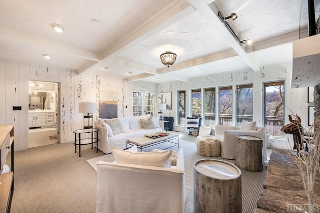 living room with coffered ceiling, beamed ceiling, and light colored carpet