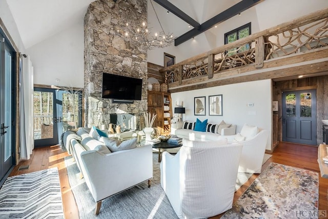 living room with hardwood / wood-style flooring, high vaulted ceiling, and a notable chandelier