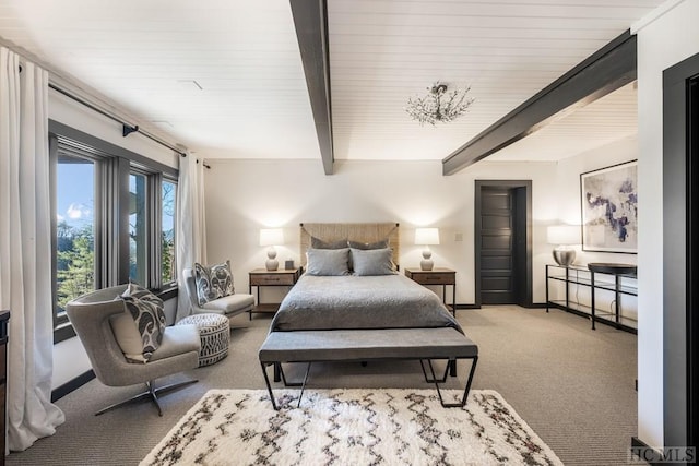 carpeted bedroom with beam ceiling