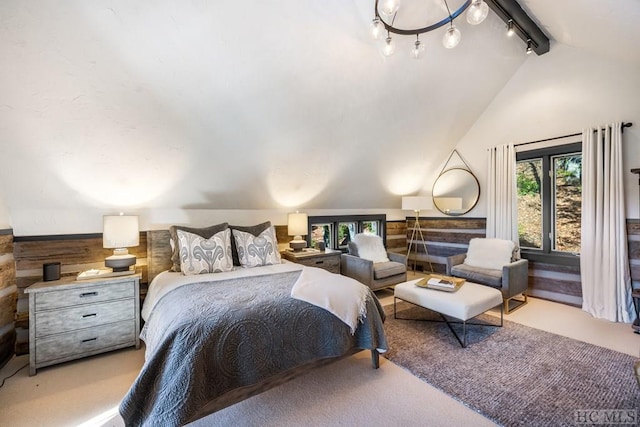 carpeted bedroom featuring vaulted ceiling with beams and track lighting