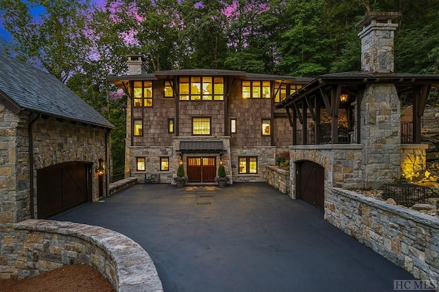 view of front of house featuring an outdoor stone fireplace